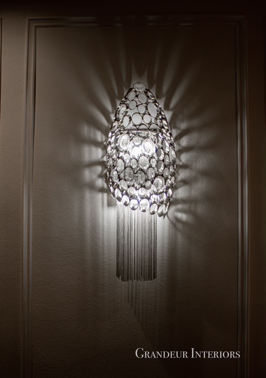 Crystal wall sconce casting sculptural light patterns