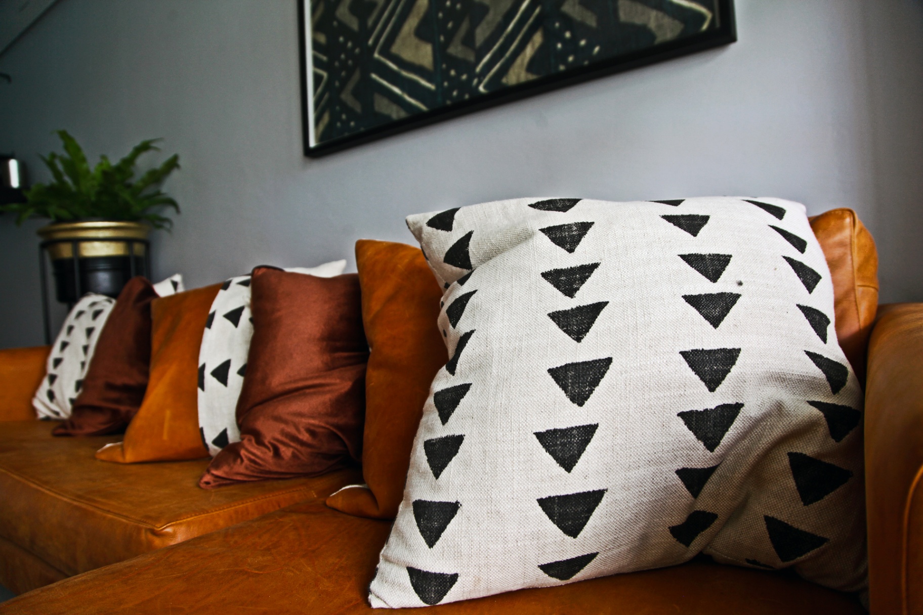 Custom scatter cushions on tan leather sofa