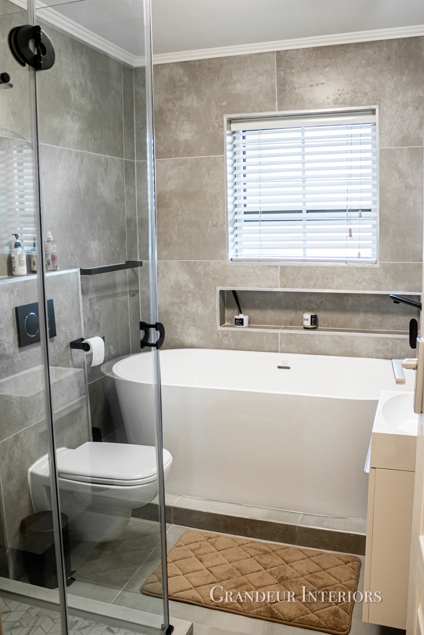 Guest bathroom with freestanding bath, glass shower and neutral finishes