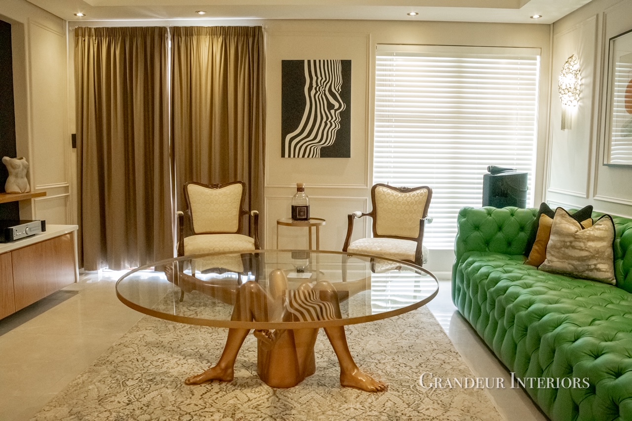 Lounge seating with occasional chairs, draped curtains and sculptural glass coffee table